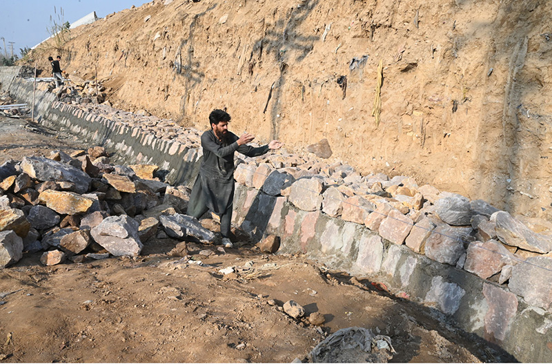 Labourers are busy with construction work near 10th Avenue as part of development activities in the Federal Capital