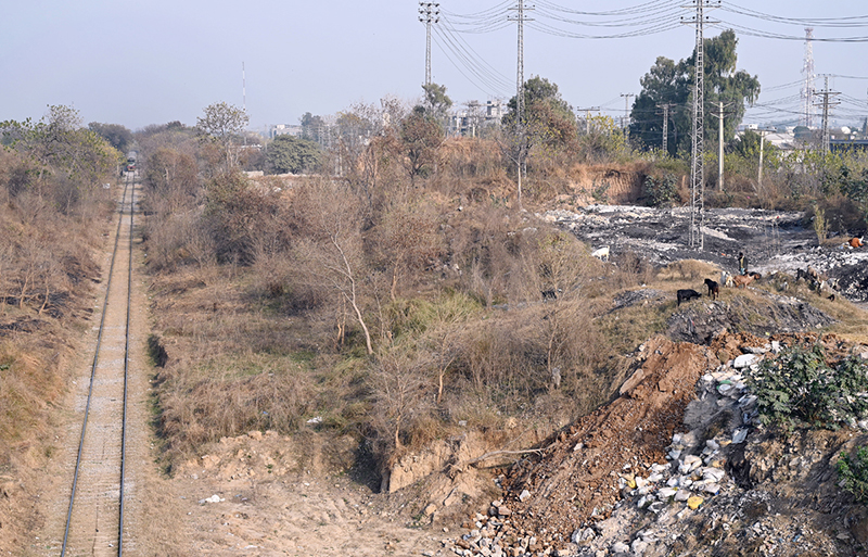 A view of a railway track near Margalla Railway Station as garbage and debris are seen dumped along the sides in the federal capital