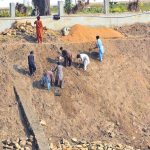 Workers of the Irrigation Department are busy preparing the canal embankments in the Jamshoro area