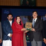Chairman Senate Syed Yousaf Raza Gillani distributes shields among participants during the oath-taking ceremony of the newly elected body of the Academic Staff Association at Bahauddin Zakariya University