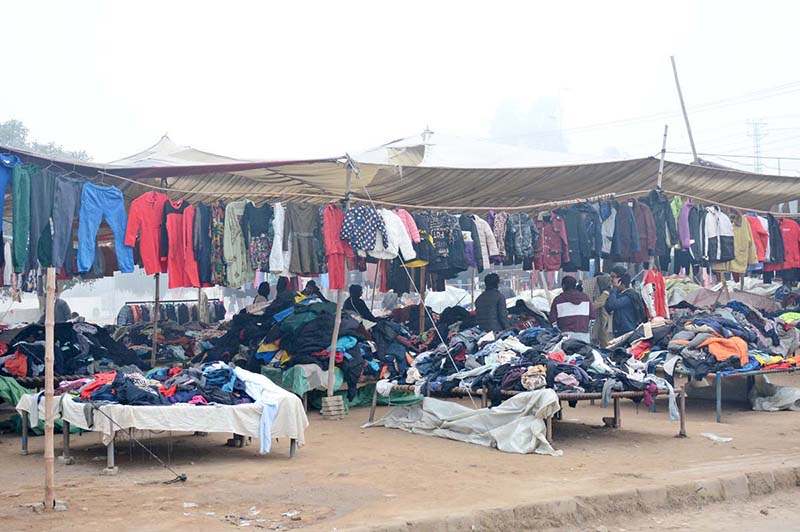 People busy selecting and purchasing used warm clothes from Landa Bazaar