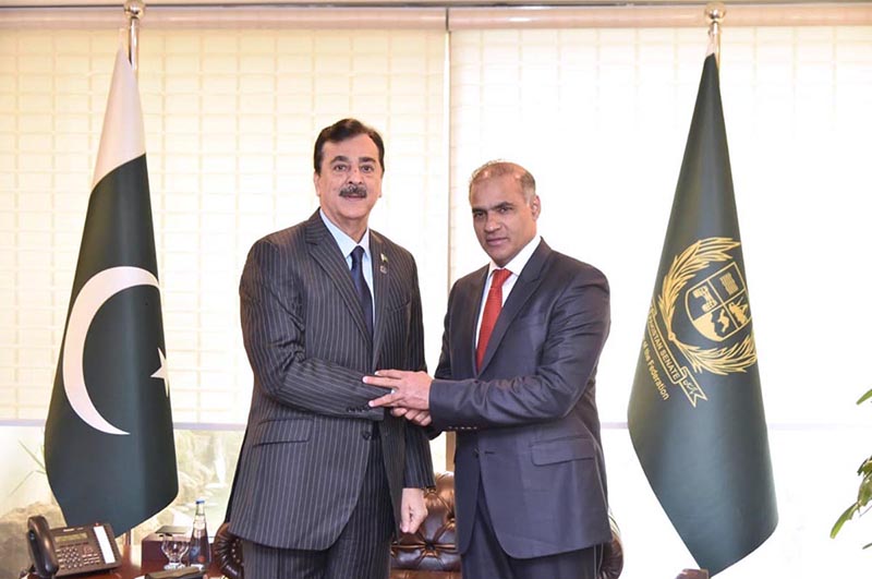 Acting President Syed Yousuf Raza Gilani Shaking hands with newly elected Senator Abid Sher Ali at the Parliament House in the federal capital
