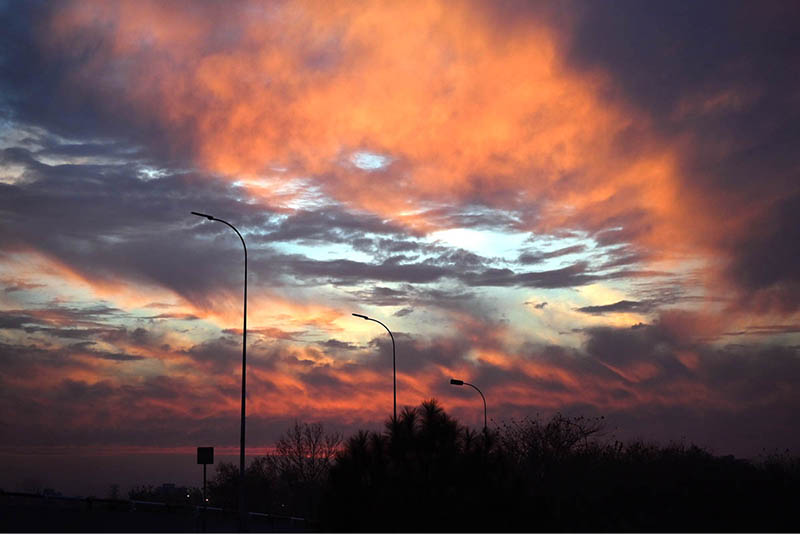 A fiery display of orange and red clouds lit up the sky during a recent sunset, casting striking silhouettes over the urban landscape of the Federal Capital