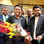 Governor Sindh Kamran Khan Tessori presents a bouquet to a passenger on the inaugural direct flight from Dhaka to Karachi