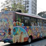 A passenger bus decorated with a Basant poster moves through the city on the first day of the spring festival, celebrated in the provincial capital after twenty years following the lifting of the Basant ban